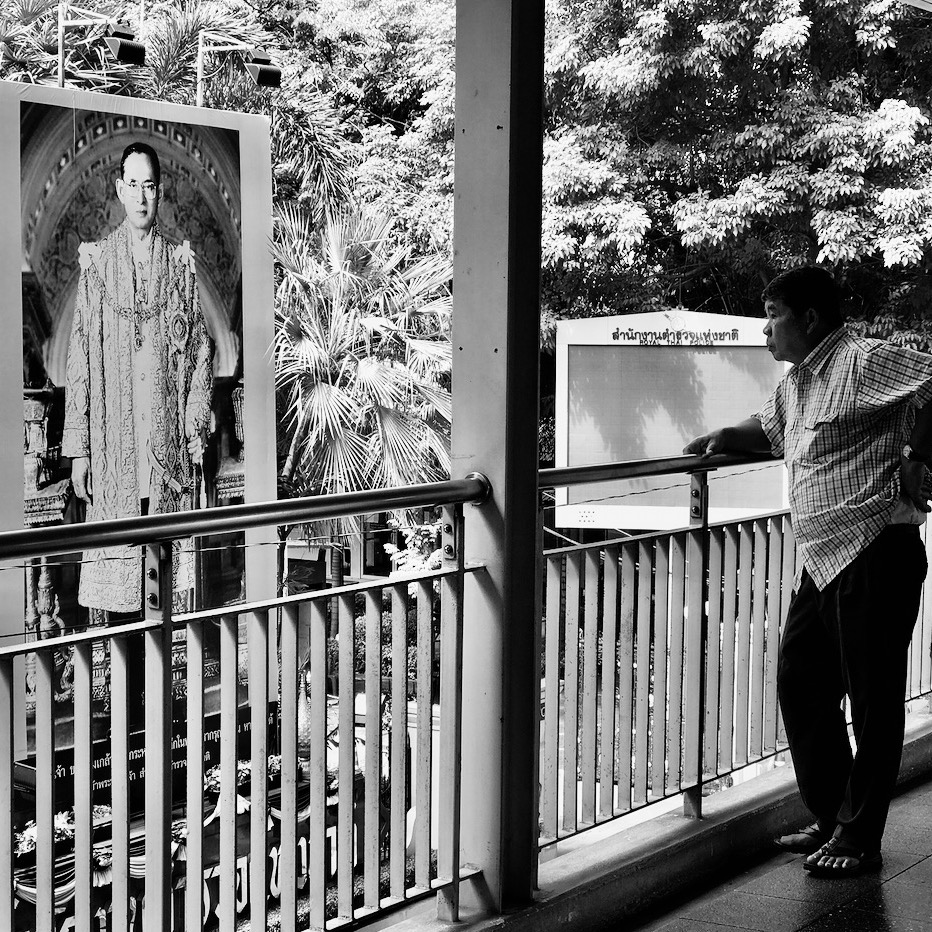 A man looks on at the late King Bhumibol in Bangkok Square Crop