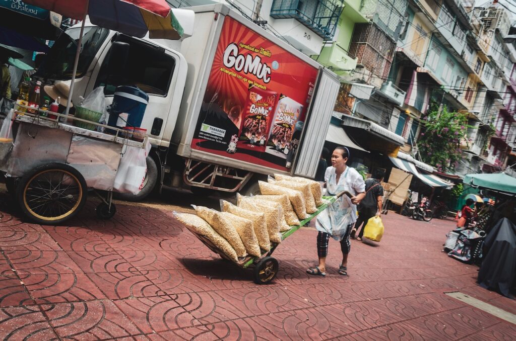 A worker at Chinatown in Bangkok hauling goods
