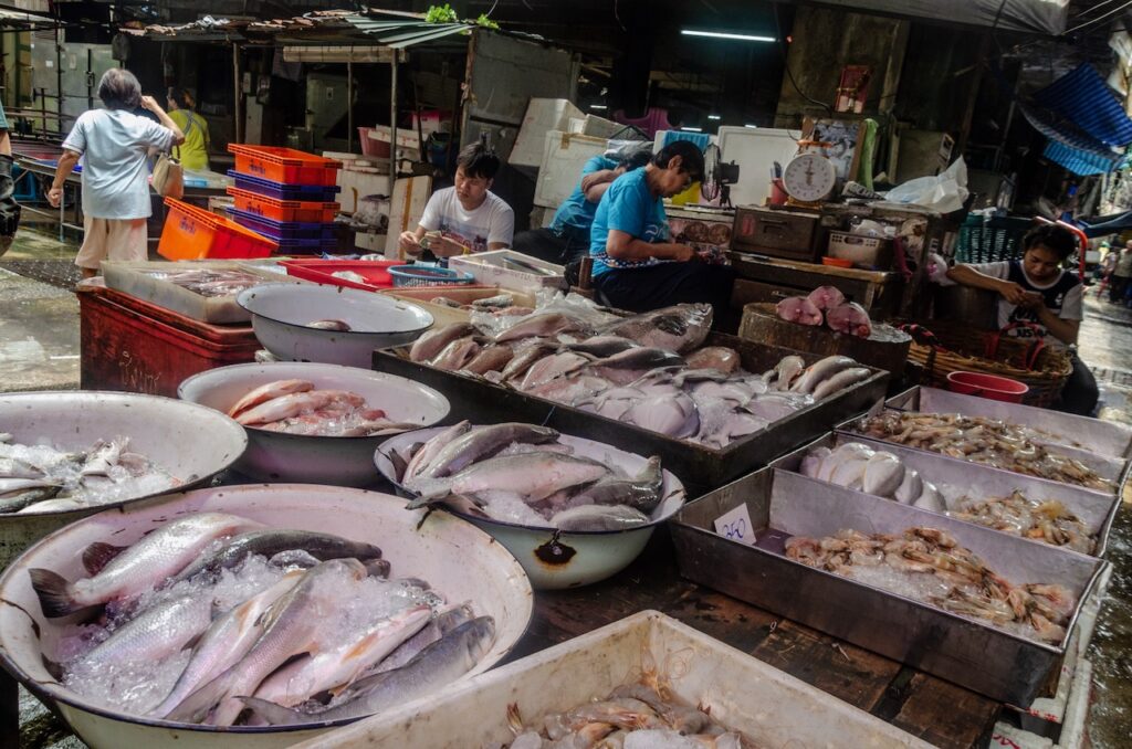 Fish seller at Bangkok Chinatown market street